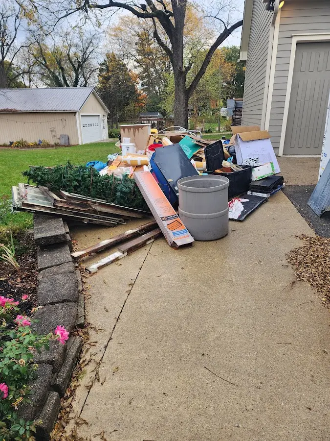 Dumpster being loaded with debris for 12 Yard Dumpster Rental in Concord